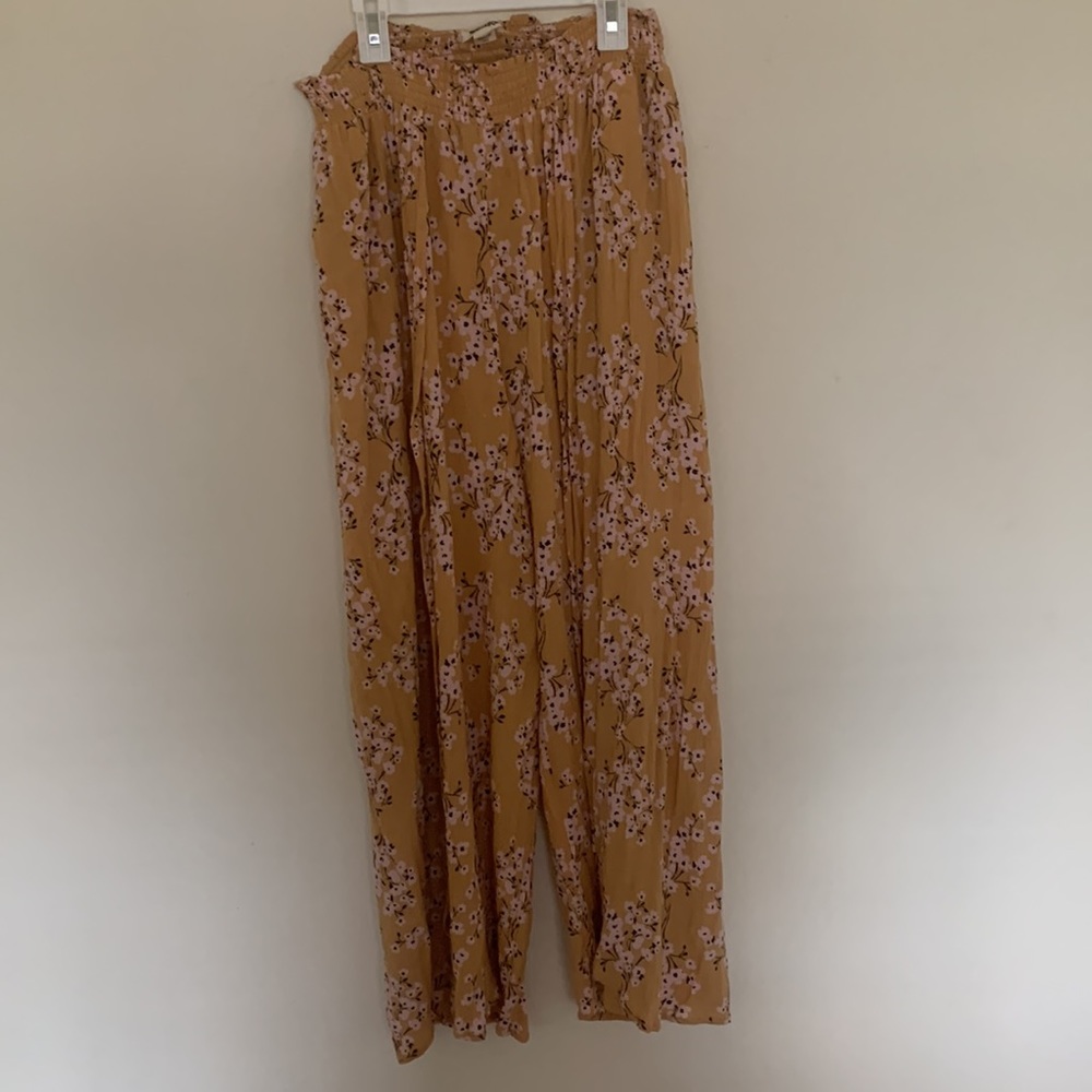 Yellow flowy pants with light pink/white flowers